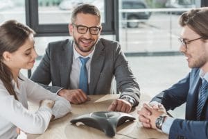 Happy businesspeople on a phone conference call
